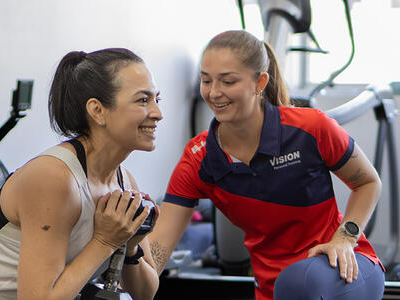Person supporting women lifting weight