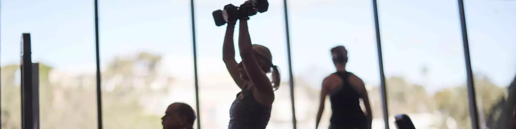 People doing weight training at a gym