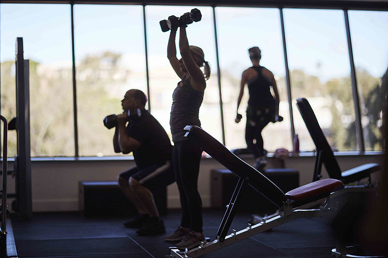 People doing weight training at a gym
