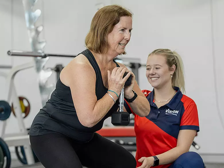 Trainer with client goblet squat 