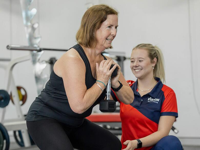 Trainer with client goblet squat 