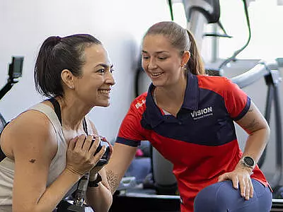 Person supporting women lifting weight