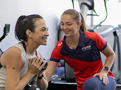 Person supporting women lifting weight